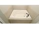 A large soaking tub sits atop tiled surround with a black faucet at 1829 Nw 85Th Loop, Ocala, FL 34475
