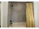 Bathroom with tiled shower and yellow floral shower curtain at 1829 Nw 85Th Loop, Ocala, FL 34475