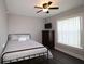 Well-lit bedroom featuring a ceiling fan, a dark wood dresser and vinyl floor at 1829 Nw 85Th Loop, Ocala, FL 34475