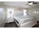 Primary bedroom with a ceiling fan, a large bed, and two nightstands at 1829 Nw 85Th Loop, Ocala, FL 34475
