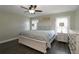 Primary bedroom with a ceiling fan, a large bed, and a nightstand at 1829 Nw 85Th Loop, Ocala, FL 34475