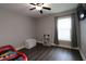 Bedroom with a bookshelf, TV, and window at 1829 Nw 85Th Loop, Ocala, FL 34475