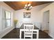 Inviting dining room with wood-look floors and a view to the front yard at 1829 Nw 85Th Loop, Ocala, FL 34475