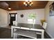 Bright dining area featuring a wooden table, white chairs, and decorative lighting at 1829 Nw 85Th Loop, Ocala, FL 34475