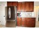 Modern kitchen featuring stainless steel appliances and rich wooden cabinetry at 1829 Nw 85Th Loop, Ocala, FL 34475