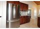 Spacious kitchen with stainless steel refrigerator, granite countertops and tile flooring at 1829 Nw 85Th Loop, Ocala, FL 34475
