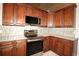 Gourmet kitchen features stainless steel appliances and custom backsplash and cabinetry at 1829 Nw 85Th Loop, Ocala, FL 34475