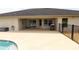 Spacious covered patio with outdoor entertaining space and views of the backyard pool at 1829 Nw 85Th Loop, Ocala, FL 34475