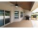 Charming covered patio with ceiling fan, offering outdoor living with BBQ and views at 1829 Nw 85Th Loop, Ocala, FL 34475