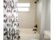 Tiled shower with floral shower curtain and bathtub at 1829 Nw 85Th Loop, Ocala, FL 34475