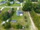 Aerial view of the home with a large backyard, shed, mature trees, and long driveway at 205 Ne 53Rd St, Ocala, FL 34479