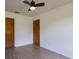 Bedroom showcasing light walls, modern floors, ceiling fan, and closet doors at 205 Ne 53Rd St, Ocala, FL 34479