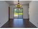 Dining room featuring a modern chandelier, tiled floors and sliding glass doors leading to the backyard at 205 Ne 53Rd St, Ocala, FL 34479