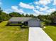 Charming single-story home featuring a well-manicured lawn, attached garage and inviting front yard at 205 Ne 53Rd St, Ocala, FL 34479