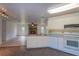 Open concept kitchen with white cabinets, tile backsplash, and an eat-in area at 205 Ne 53Rd St, Ocala, FL 34479