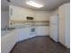 Well-maintained kitchen features white cabinets, white appliances and laminate countertops at 205 Ne 53Rd St, Ocala, FL 34479