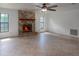 Living room featuring a cozy brick fireplace, tile flooring, and ample natural light at 205 Ne 53Rd St, Ocala, FL 34479