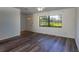 Inviting living room featuring modern wood-look floors, a large window, and ample natural light at 205 Ne 53Rd St, Ocala, FL 34479
