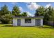Outdoor shed featuring gray trim, double doors, and a window at 205 Ne 53Rd St, Ocala, FL 34479
