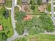 Aerial view of the neighborhood with trees surrounding the house with the red roof at 2676 Se 52Nd Ave, Ocala, FL 34480