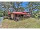 Wide view of the backyard showing the covered patio and mature landscaping at 2676 Se 52Nd Ave, Ocala, FL 34480