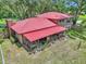 Drone view of the backyard showing the patio, landscaping, and mature trees at 2676 Se 52Nd Ave, Ocala, FL 34480