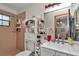 Full bathroom featuring a shower and a vanity with a sink, a wooden framed mirror and storage at 2676 Se 52Nd Ave, Ocala, FL 34480