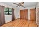 Bedroom featuring hardwood floors, ceiling fan, and a large window at 2676 Se 52Nd Ave, Ocala, FL 34480