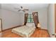 Bedroom featuring wood floors, neutral paint, ceiling fan, window with dark curtains and lamps at 2676 Se 52Nd Ave, Ocala, FL 34480