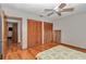 Bedroom features wood floors, neutral walls, ceiling fan, closet and connected bathroom at 2676 Se 52Nd Ave, Ocala, FL 34480