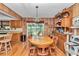 Inviting dining room with wood paneled walls and a view of the backyard through sliding glass doors at 2676 Se 52Nd Ave, Ocala, FL 34480