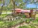Home with brick and siding, a red roof, and manicured landscaping at 2676 Se 52Nd Ave, Ocala, FL 34480