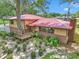 Home featuring a red roof, and manicured landscaping surrounding a mature tree at 2676 Se 52Nd Ave, Ocala, FL 34480