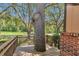 Unique front porch featuring a mature tree integrated into the design at 2676 Se 52Nd Ave, Ocala, FL 34480