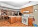 Open kitchen area featuring a breakfast bar, white appliances, and view of the dining and living rooms at 2676 Se 52Nd Ave, Ocala, FL 34480