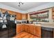 Functional kitchen with wooden cabinets, laminate countertops, and up-to-date appliances at 2676 Se 52Nd Ave, Ocala, FL 34480