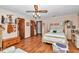 Bright bedroom with wood floors, a four-poster bed, and neutral walls with white trim at 2676 Se 52Nd Ave, Ocala, FL 34480