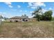 Large backyard with a patio, offering plenty of space for activities and gatherings, and neighboring houses at 2690 Sw 154Th Ln, Ocala, FL 34473