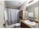 This bathroom includes a shower with curtain, a cabinet, and a granite countertop at 2690 Sw 154Th Ln, Ocala, FL 34473