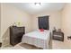 This bedroom includes a single bed with floral sheets, black curtains, and dark wood furnishings at 2690 Sw 154Th Ln, Ocala, FL 34473