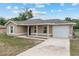 Single-story home featuring an attached garage, covered porch, and freshly painted exterior at 2690 Sw 154Th Ln, Ocala, FL 34473