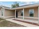 Inviting front porch with decorative columns, a stylish front door, and manicured landscaping at 2690 Sw 154Th Ln, Ocala, FL 34473