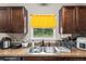 Close-up of the kitchen sink with stainless steel fixtures and a view of the backyard at 2690 Sw 154Th Ln, Ocala, FL 34473