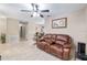 Inviting living room with tile flooring and a comfortable leather reclining loveseat at 2690 Sw 154Th Ln, Ocala, FL 34473