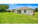 Backyard view with lush green lawn extending from the back of the home at 2792 Se 29Th St, Ocala, FL 34471
