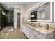 Bathroom with a lighted mirror, double vanity with stone countertop and views to the shower and toilet area at 2792 Se 29Th St, Ocala, FL 34471