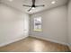 Cozy bedroom offers neutral walls, window view, and modern ceiling fan at 2792 Se 29Th St, Ocala, FL 34471