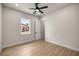 Bright bedroom features a ceiling fan, natural light, and light wood-look tile floors at 2792 Se 29Th St, Ocala, FL 34471