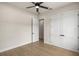 Bedroom with light-colored walls, wood-look flooring, a ceiling fan and entry doors at 2792 Se 29Th St, Ocala, FL 34471