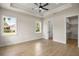 Bedroom with a tray ceiling, light wood flooring, lots of natural light, and a walk-in closet at 2792 Se 29Th St, Ocala, FL 34471